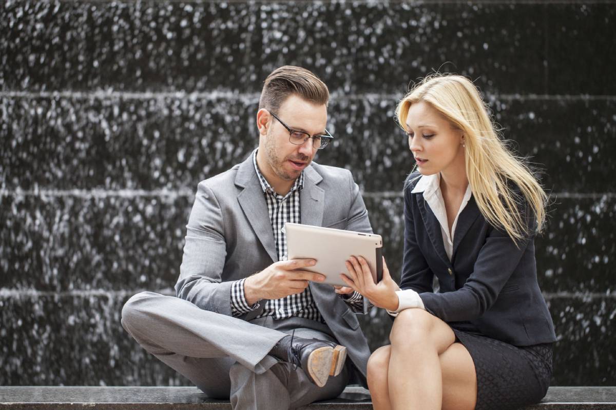 Businessman and woman collaborating using a tablet